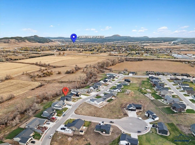 birds eye view of property with a mountain view