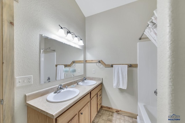 bathroom with vanity and vaulted ceiling