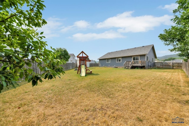 view of yard with a playground and a deck