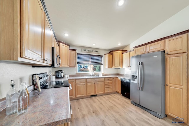 kitchen featuring sink, light hardwood / wood-style floors, vaulted ceiling, light brown cabinetry, and black appliances