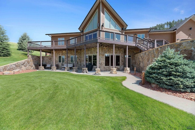 back of house featuring a lawn, a balcony, and a patio