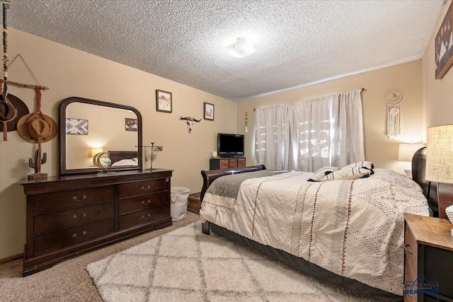 bedroom with light carpet and a textured ceiling