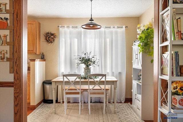 dining area with a textured ceiling