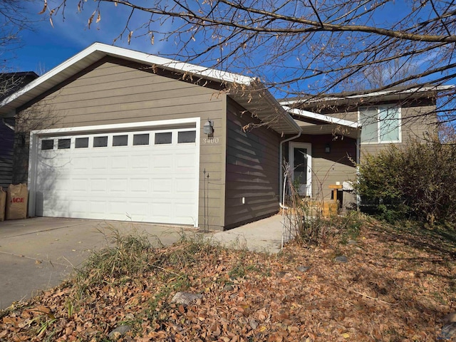 view of side of home featuring a garage