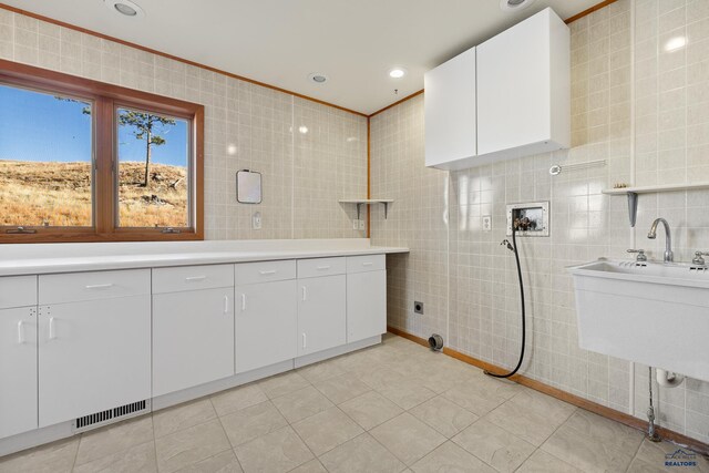 bathroom with tile patterned flooring and tile walls