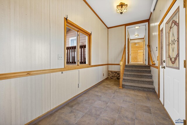 foyer entrance featuring crown molding