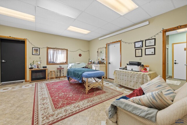 bedroom featuring tile patterned flooring and a paneled ceiling