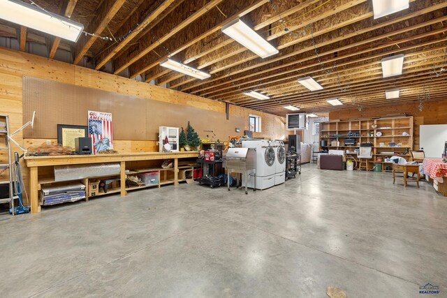 garage with a workshop area and washing machine and dryer