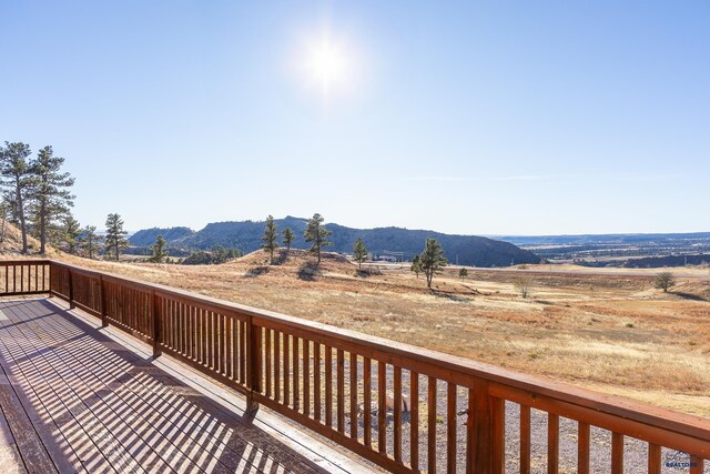 wooden terrace featuring a mountain view and a rural view