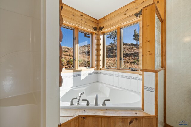 bathroom with a mountain view and a bathtub