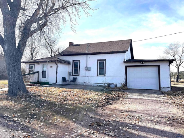 back of property with a garage