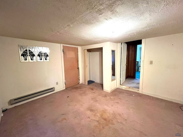 unfurnished bedroom with baseboard heating, carpet, and a textured ceiling