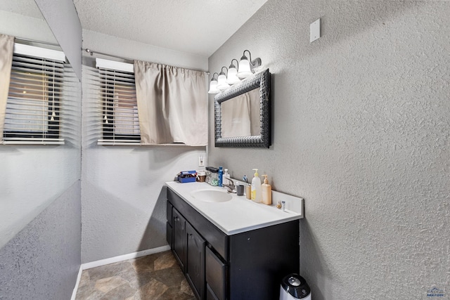 bathroom with vanity and a textured ceiling