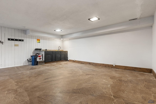 garage with sink and wooden walls