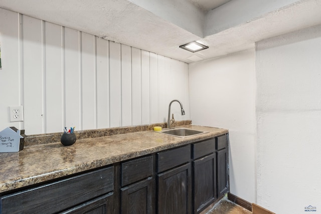 bathroom with a textured ceiling and sink