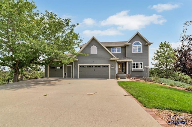 craftsman inspired home with a garage and a front yard