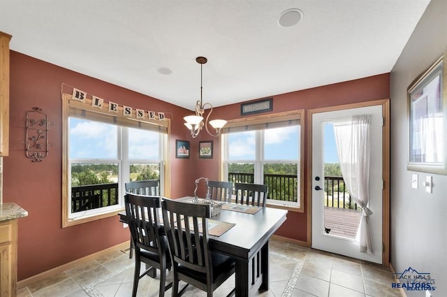 dining area featuring light tile patterned floors and a notable chandelier