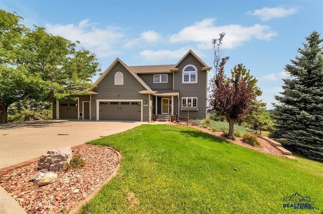 view of front of home with a garage and a front yard