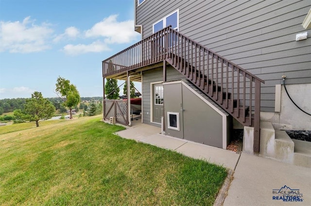 exterior space featuring a yard and a wooden deck