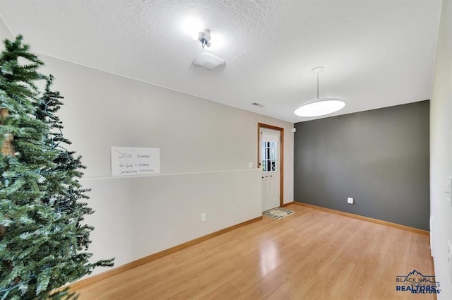 interior space with hardwood / wood-style floors and a textured ceiling