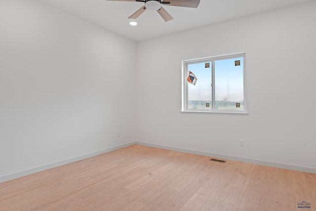 spare room featuring ceiling fan and light hardwood / wood-style floors