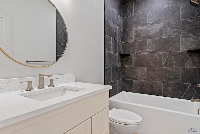 full bathroom featuring vanity, toilet, and tiled shower / bath