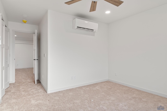 carpeted spare room with ceiling fan and an AC wall unit