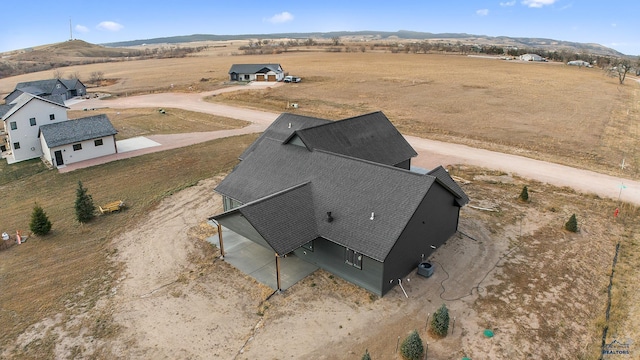 birds eye view of property with a mountain view and a rural view