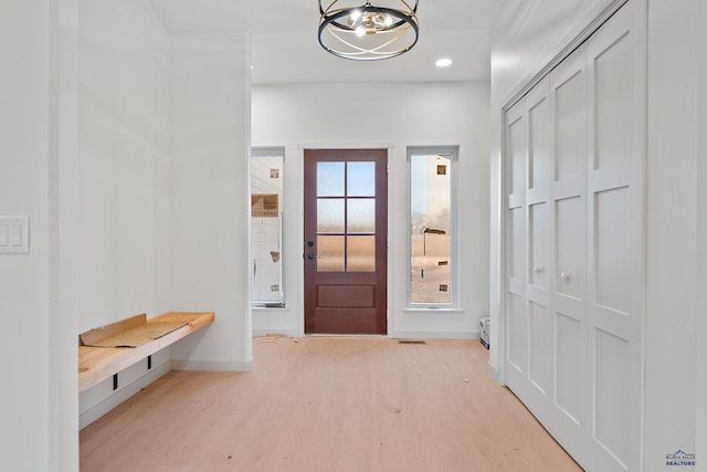 interior space featuring light hardwood / wood-style flooring and a notable chandelier