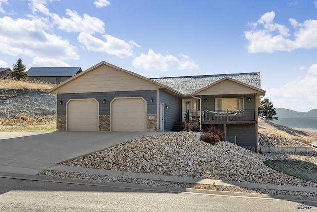 view of front of home with a mountain view and a garage