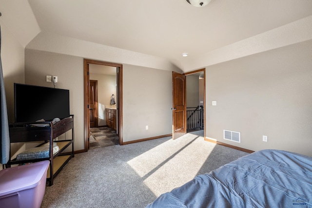 bedroom featuring carpet floors and ensuite bath