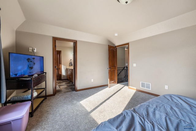 bedroom with carpet flooring and connected bathroom