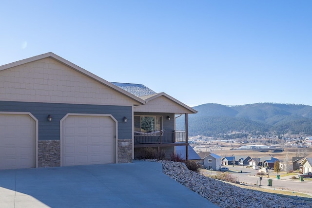 view of front of house with a mountain view, covered porch, and a garage