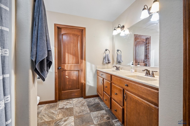 bathroom with vanity and toilet