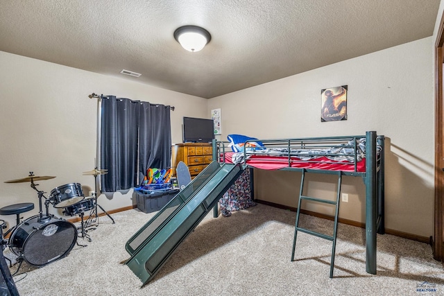 carpeted bedroom with a textured ceiling