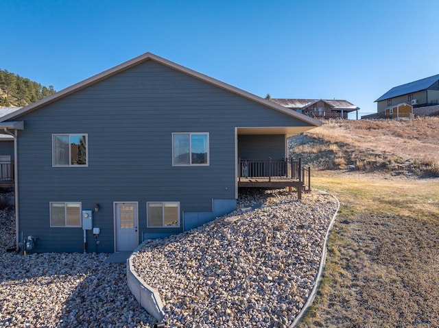 back of house with a deck