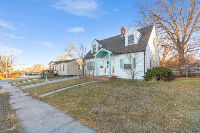 new england style home featuring a front yard