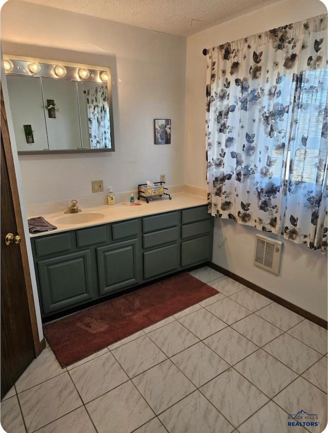bathroom featuring vanity and a textured ceiling