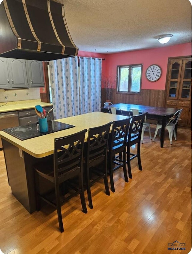 dining room featuring a textured ceiling and light hardwood / wood-style flooring