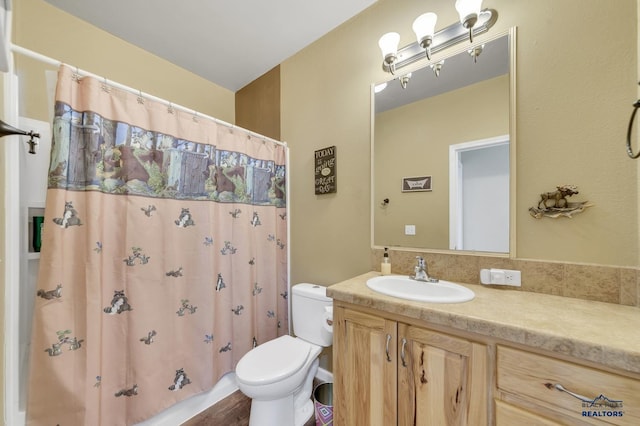 bathroom with hardwood / wood-style flooring, vanity, and toilet