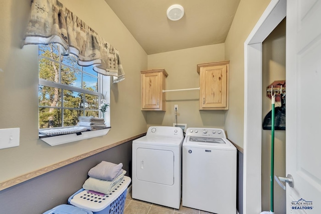 laundry area with cabinets, light tile patterned floors, and washing machine and dryer