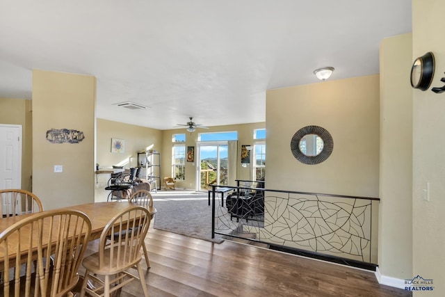 dining space with wood-type flooring and ceiling fan