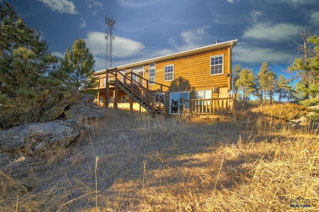 rear view of property featuring a deck