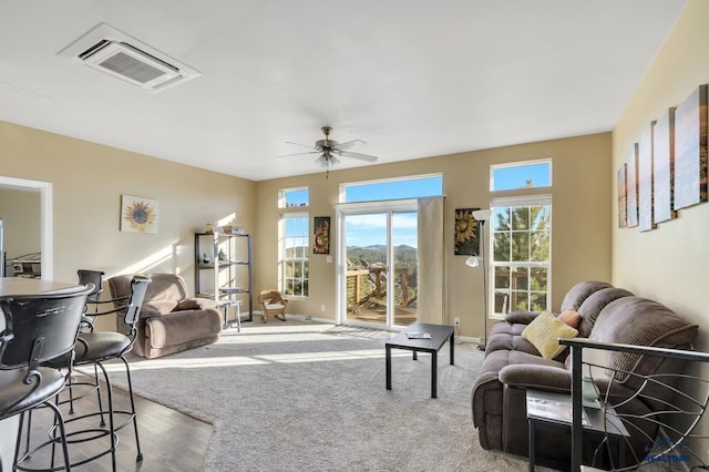 living room with ceiling fan and carpet floors