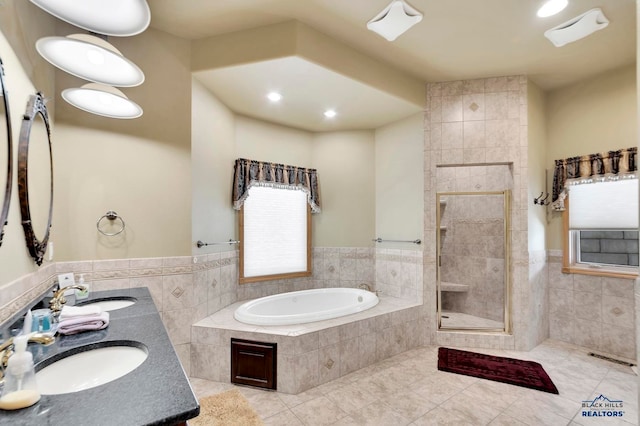 bathroom with tile patterned floors, vanity, and tile walls