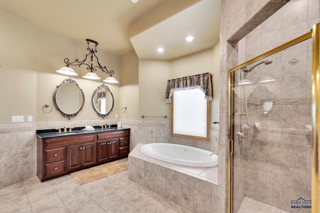 bathroom with tile patterned floors, vanity, and independent shower and bath