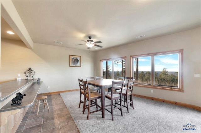 tiled dining room with ceiling fan