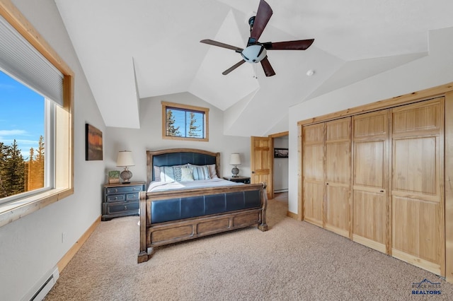 bedroom with baseboard heating, ceiling fan, a closet, and lofted ceiling