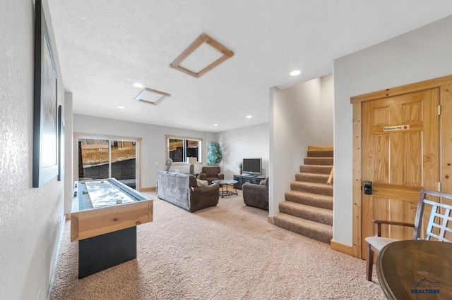 game room featuring carpet floors and a textured ceiling