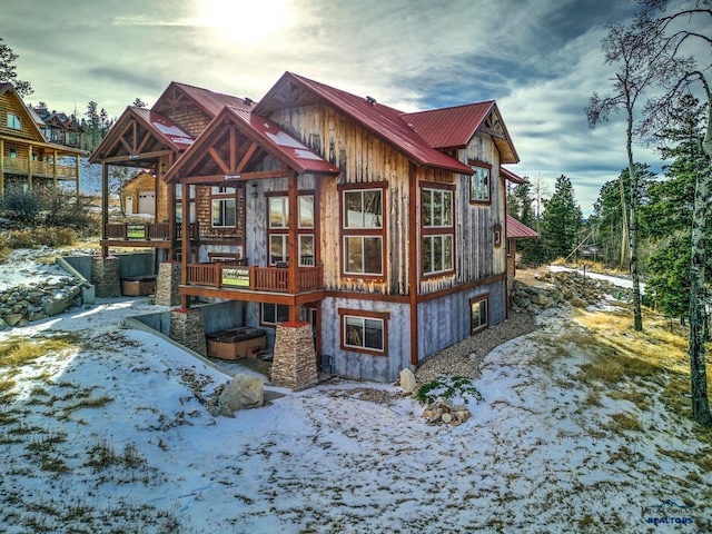 view of snow covered back of property